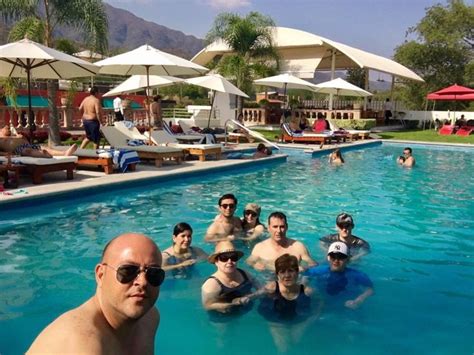 a group of people sitting in the middle of a swimming pool