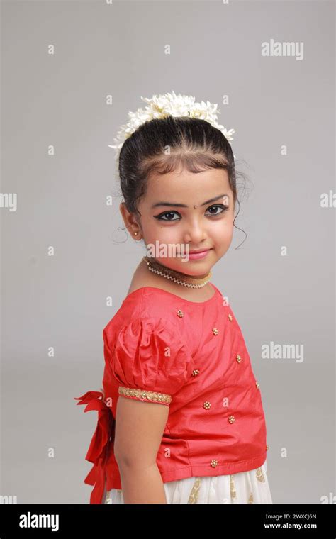 A cute small girl child wearing Kerala dress-golden colour long skirt ...