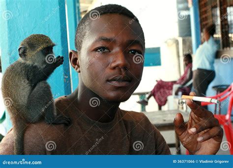 Tame Monkey, Sits on Shoulder of Young, Black Man African. Editorial ...