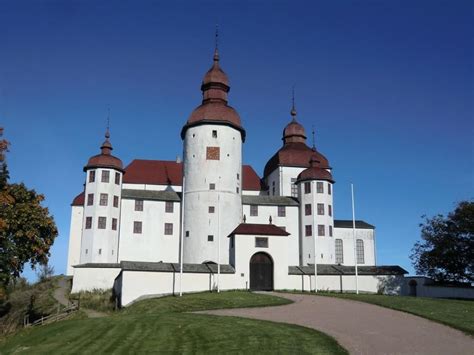 a large white castle sitting on top of a lush green field