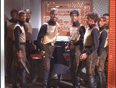 a group of men standing next to each other in front of a tv screen with the words star trek ...