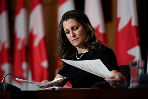 Behind the photo of Chrystia Freeland holding a black-and-red scarf at ...