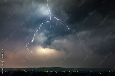 Lightnings over city during thunderstorm Stock Photo | Adobe Stock