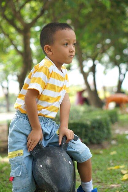 Premium Photo | Happy boy playing in the park