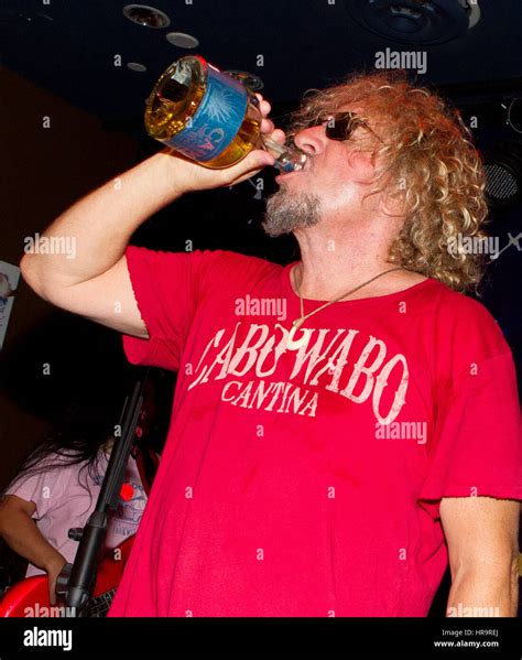 Sammy Hagar holds a bottle of Cabo Wabo Tequila while on stage with his ...