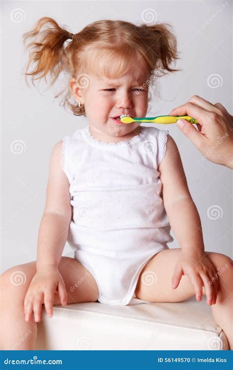 Crying Baby Getting Her Teeth Brushed Stock Photo - Image of childhood, dislike: 56149570