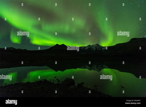 Green aurora light behind Lake mountain in iceland europe at national ...