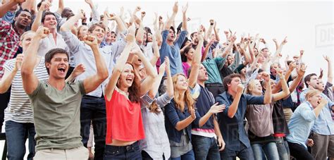 Cheering fans in crowd - Stock Photo - Dissolve