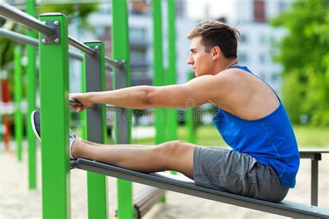 Young Man Doing Sit-ups at Outdoor Gym Stock Photo - Image of fitness, healthy: 62570394