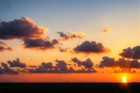 Premium Photo | A sunset with a blue sky and clouds