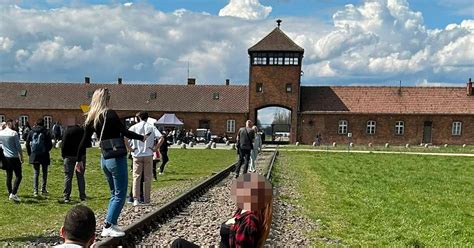 Auschwitz museum urges visitors to respect site after woman's photo ...