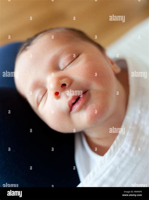 Portrait of sleeping newborn baby girl with smile Stock Photo - Alamy