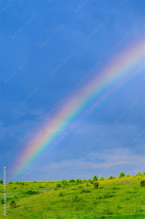 Very beautiful gentle spring photo. Rainbow on the field after rain ...