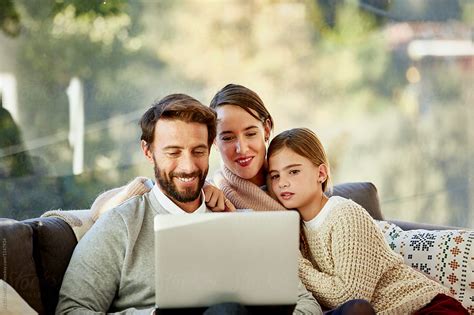 "Happy Man With Family Working On Laptop At Home" by Stocksy ...