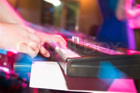 Musician plays keyboards in a rock band | Stock image | Colourbox