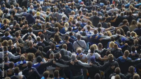 Happy football soccer fans hugging, dancing in joy at stadium ...