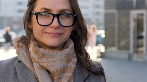 Portrait of a woman with a hairstyle and neutral makeup on a city background closeup 22749571 ...