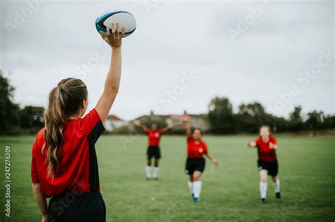 Female rugby player ready to throw the ball Stock Photo | Adobe Stock