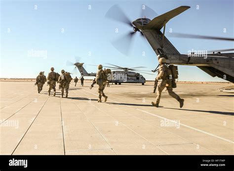 U.S. Marines with Bravo Company, 1st Battalion, 5th Marines (1/5) board two CH-53 Super Stallion ...