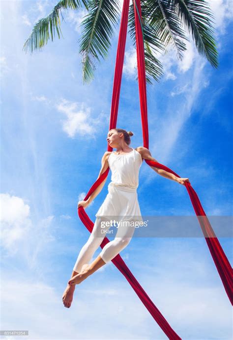 Woman practicing aerial silk yoga outdoors | Aerial silks, Yoga ...