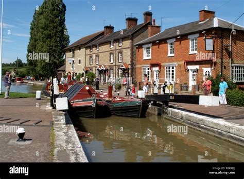 Working canal boats enter lock Grand Union Canal at Stoke Bruerne ...