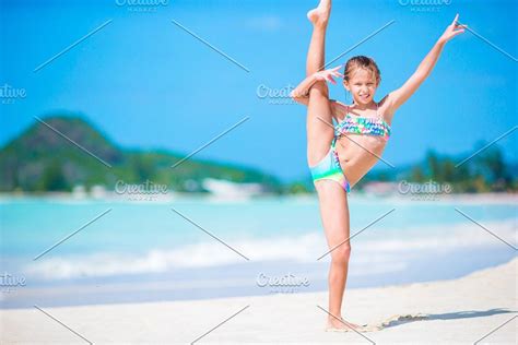 Beautiful little girl on beach having fun happy girl enjoy summer ...