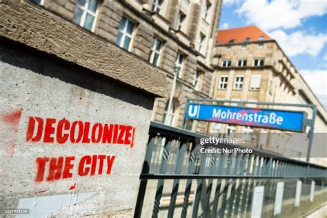 A graffitti reading 'Decolonize the city' is seen at the entrance of ...