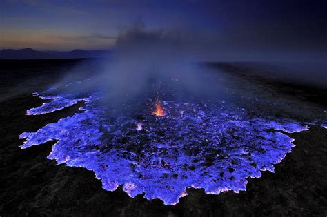 Blue lava erupting from the Kawah Ijen volcano in Indonesia. The mountain contains large amounts ...