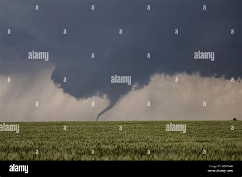 Tornado with funnel cloud moving across plains Stock Photo - Alamy