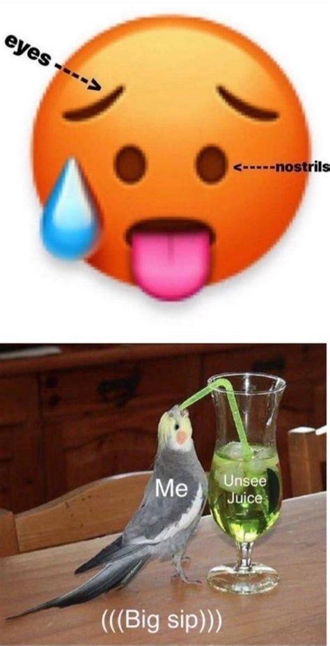 a bird sitting on top of a table next to a glass filled with green liquid