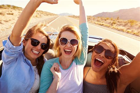 Three Female Friends On Road Trip In Back Of Convertible Car - Travel ...