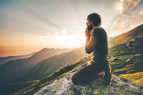 Man praying at sunset mountains Travel Lifestyle stock photography ...