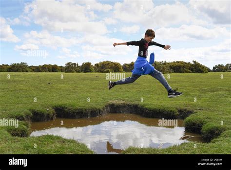 Jumping over puddle hi-res stock photography and images - Alamy