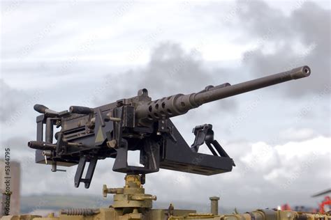 A large machine gun mounted on a military vehicle Stock Photo | Adobe Stock