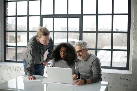 Serious multiethnic people working together in workspace · Free Stock Photo