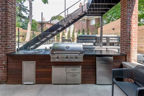 Modern backyard design with fireplace, outdoor kitchen and deck