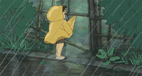 a person in a yellow raincoat holding an umbrella