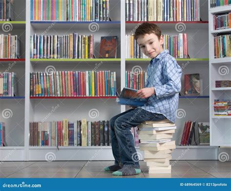 Cute Boy Reading Book in Library Stock Image - Image of book, concept: 68964569