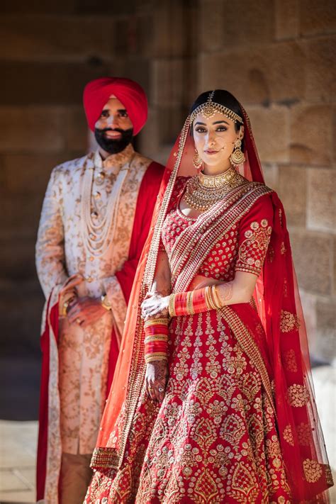 Photo of A color-coordinated couple posing on their wedding day.