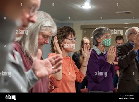 Ypsilanti, Michigan - Dr. Mary Healy (orange top) leads a Catholic prayer group at her home. Dr ...