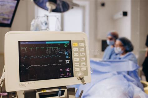 Medical Researcher Examining EKG Image Showing on Monitor while Patinet ...