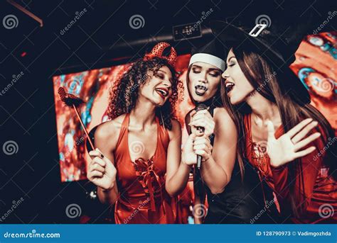 Young Women in Halloween Costumes Singing Karaoke Stock Image - Image ...