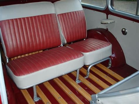 the interior of an old car with red and white seats