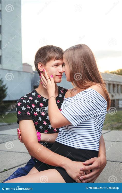 Boyfriend Hugging His Girlfriend, she Was Sitting on His Hands Stock ...