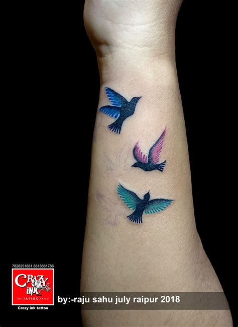 coloured flying bird tattoo for girl tattoo on wrist done at crazyink ...