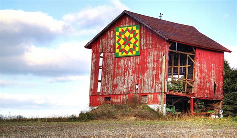 https://flic.kr/p/drF3tz | Red Barn with Quilt | A red barn in need of repairs sports a colorful ...