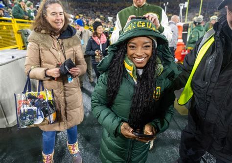 Simone Biles wore Athleta coat to Green Bay Packers game at Lambeau