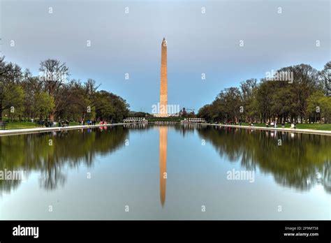 Washington Monument reflecting in the Lincoln Memorial Reflecting Pool at sunset in Washington ...