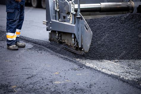 Premium Photo | Asphalt paving machine adding new asphalt for road ...