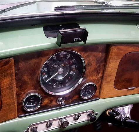 an old car dashboard with wood paneling and gauges